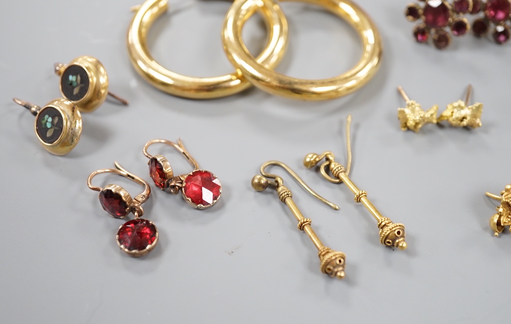 Eight assorted pairs of yellow metal or yellow metal and gem set earrings, including two pairs of Victorian garnet set, coral bead set, nugget and 9ct gold hoop